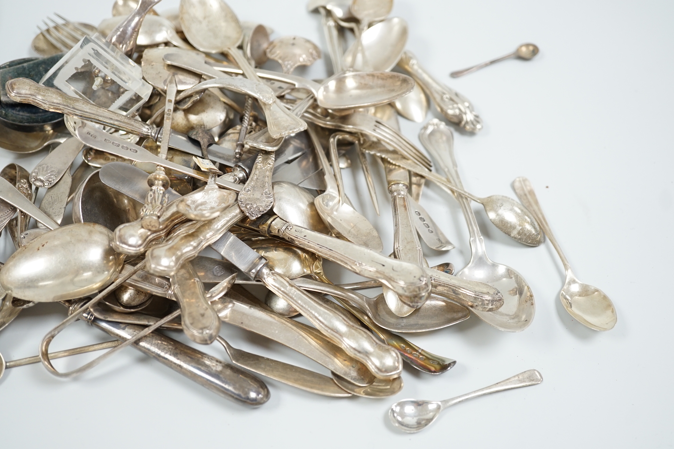 Sundry silver and white metal flatware including a George III silver Old English pattern basting spoon, London, 1782, teaspoons, condiments spoons, sifter spoon, caddy spoon etc.